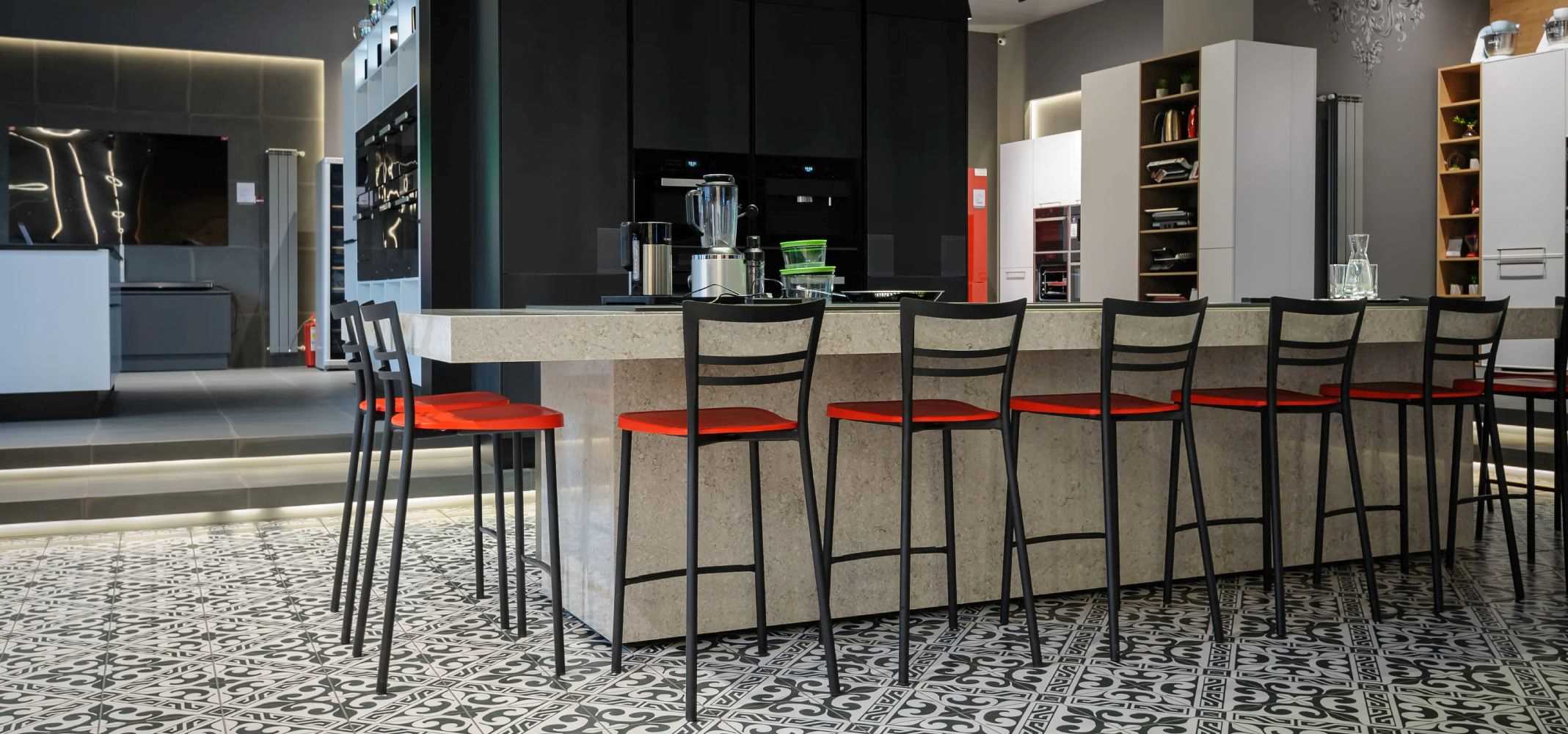 Metal Bar Stools with an Industrial design placed along a marble counter in a kitchen