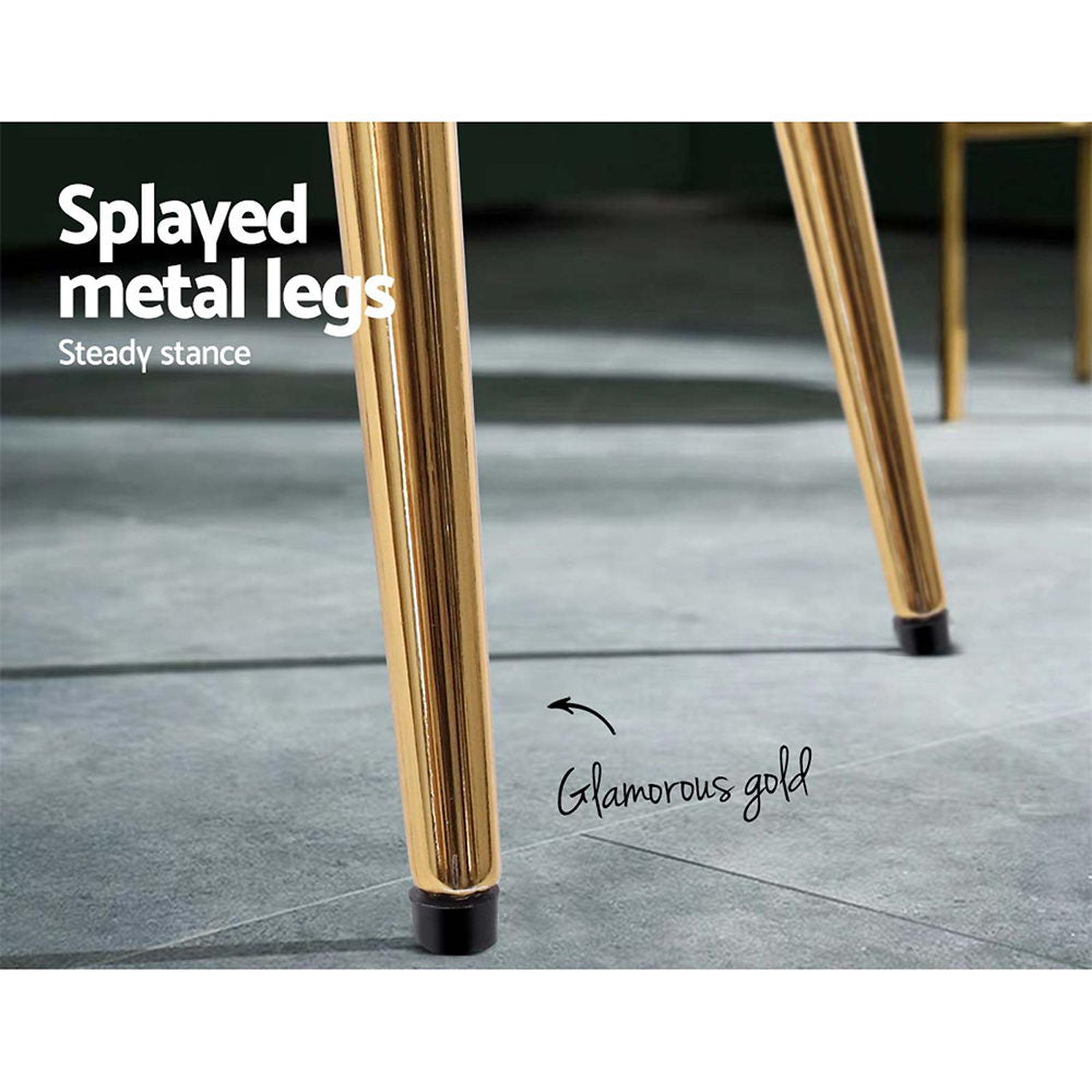 Splayed metal legs for a steady stance, adding a touch of glamour in glamorous gold