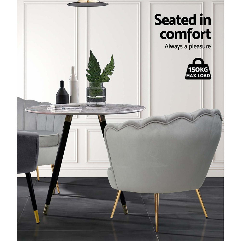 Indulge in luxurious sophistication with our Lotus Flower Shaped Grey Velvet Accent Chair. This exquisite piece adds opulence and charm to any living space, blending timeless design with ultimate comfort. Elevate your home decor with this unique and stylish chair.